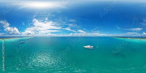 Fototapeta Naklejka Na Ścianę i Meble -  Luxury yacht next to one of the atolls of the Maldives. Aerial seamless spherical 360 degree panorama