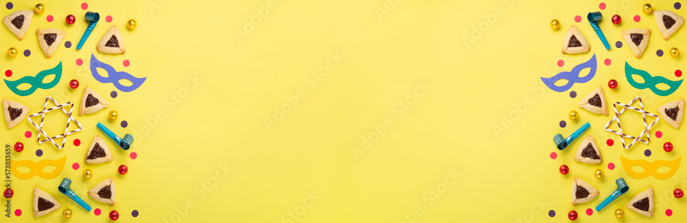 Hamantaschen Cookies, Carnival Mask, Noisemaker on Yellow Background. Purim Celebration, Jewish Carnival Holiday Concept. Hamantaschen Cookies, Carnival Mask, Noisemaker on Yellow Background. Purim Celebration, Jewish Carnival Holiday Concept.