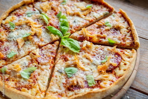 crispy crust cheesy pizza with basil and chicken 