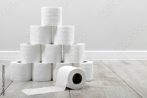 A pyramid built from white soft toilet paper in interior background