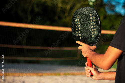 Man holding beach tennis racket. Male hand with beach tennis racket