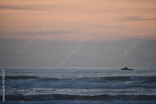 fishing vessel just off the coast at dusk © Trevor Cook