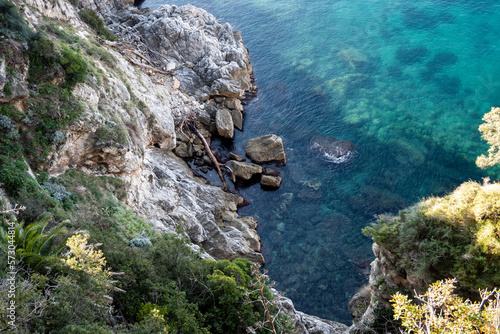 Beautiful, steep, rocky cliffs above Dubrovnik beaches with crystal clear water showing submerged stone bottom