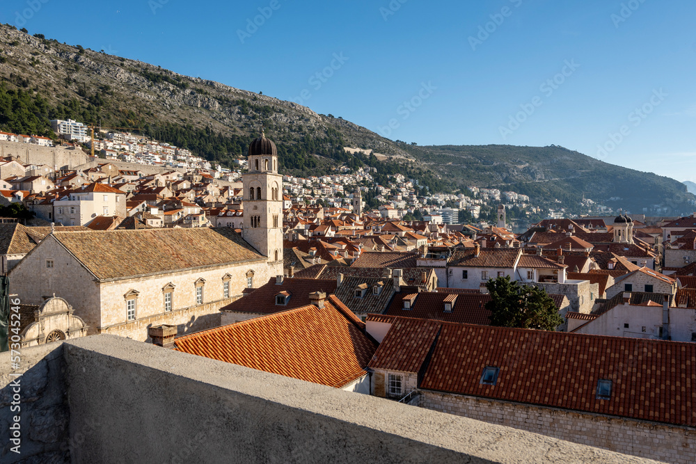 Beautiful church tower of the Franciscan Church and Monastery, rising above red rooftops of Dubrovnik city, Croatia
