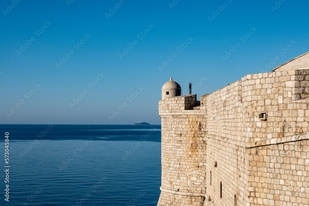 Old gun towers on the Dubrovnik city fortified walls looking on the horizon above Adriatic sea, Croatia