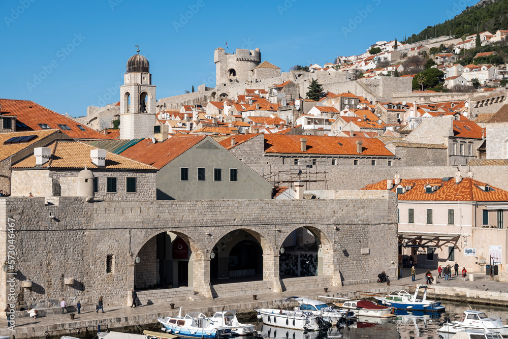 Dubrovnik city port full with anchored boats, observed from the fortified city walls