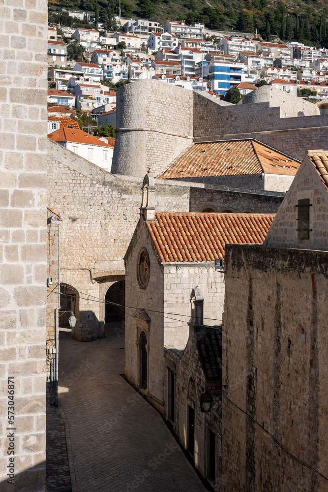 Beautiful old, Dubrovnik city streets, encircled with medieval, stone walls and modern houses built on the hill slope above the city