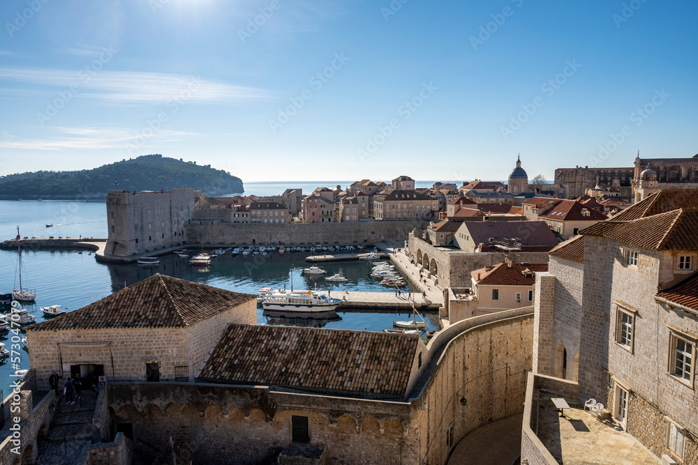 Sea view from Dubrovnik city walls, above red rooftops and anchored boats in city port