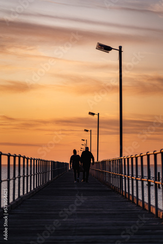 silhouette of a man walking on the pier