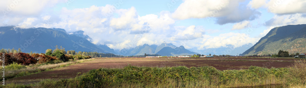 Fototapeta premium Farm fields in a valley between mountains