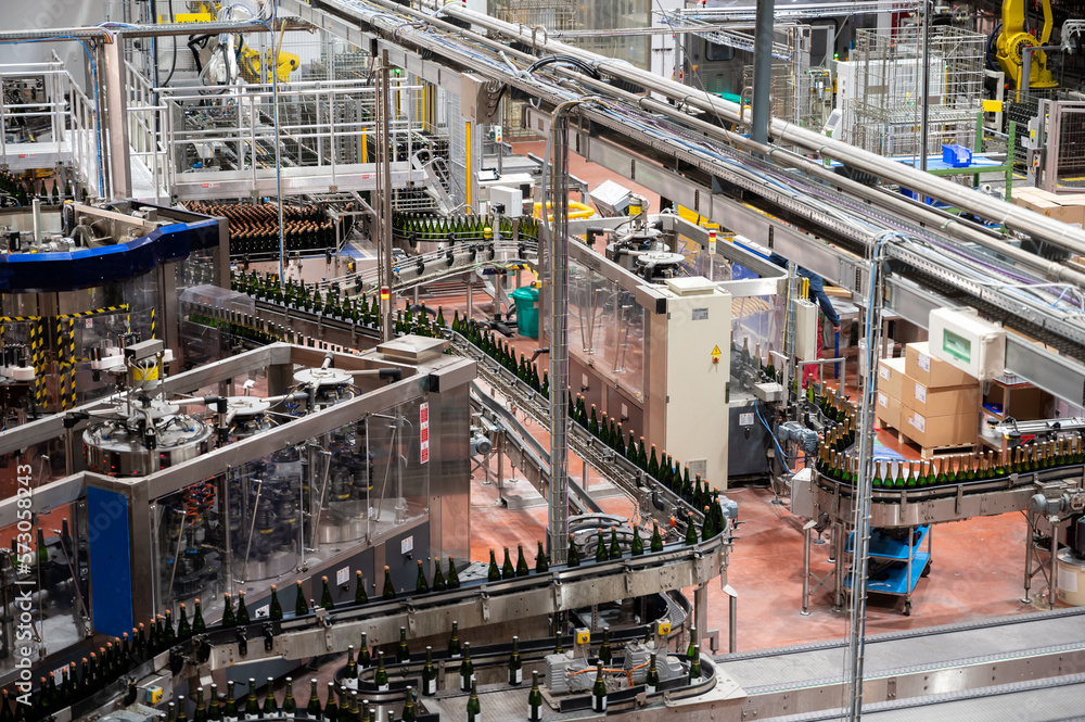 Production of cremant sparkling wine in Burgundy, France. Automatically powered bottling lines on factory.