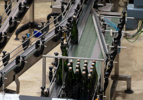 Production of cremant sparkling wine in Burgundy  France. Automatically powered bottling and riddling lines on factory.