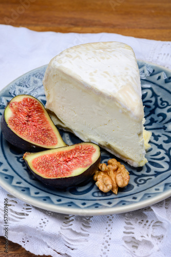 Delice de Bourgogne French cow's milk cheese from Burgundy region of France served with fresh figs and walnuts