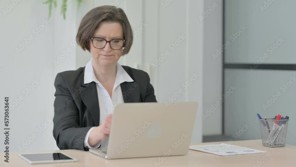 Old Businesswoman Reacting to Loss While Working in Office Old Businesswoman Reacting to Loss While Working in Office