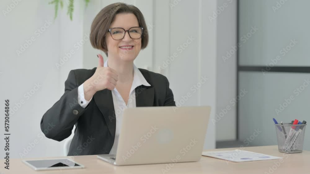 Thumbs Up by Old Businesswoman Working on Laptop Thumbs Up by Old Businesswoman Working on Laptop