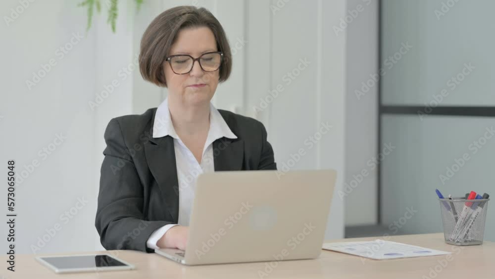 Old Businesswoman Shaking Head in Rejection while Working on Laptop Old Businesswoman Shaking Head in Rejection while Working on Laptop
