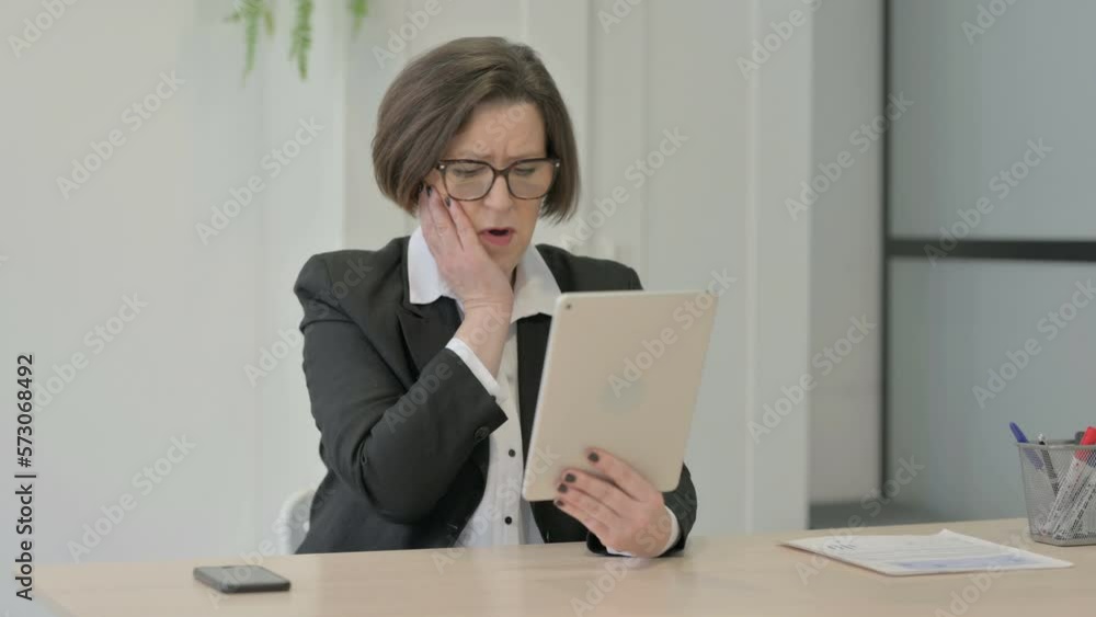 Old Businesswoman Reacting to Loss on Digital Tablet Old Businesswoman Reacting to Loss on Digital Tablet