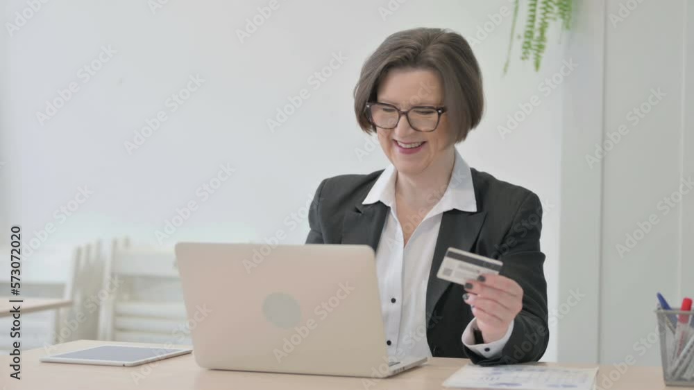 Old Businesswoman making Successful Online Payment on Laptop Old Businesswoman making Successful Online Payment on Laptop