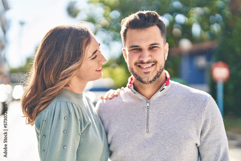 Fototapeta premium Man and woman smiling confident hugging each other standing at street