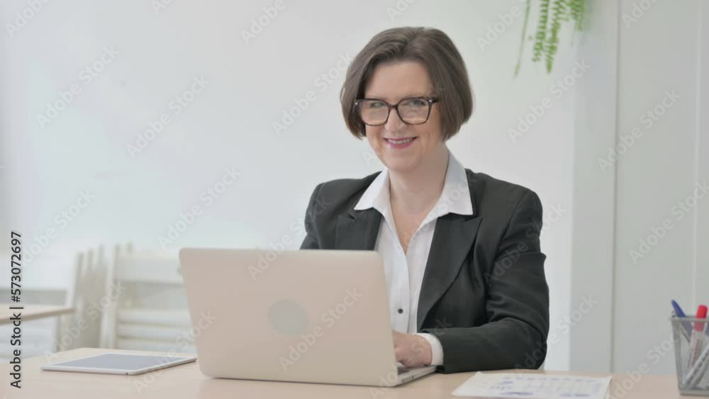 Thumbs Up by Old Businesswoman Working on Laptop Thumbs Up by Old Businesswoman Working on Laptop