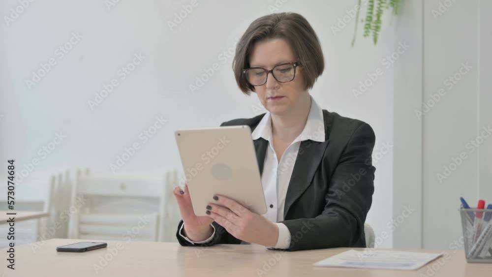 Old Businesswoman using Digital Tablet for Work Old Businesswoman using Digital Tablet for Work