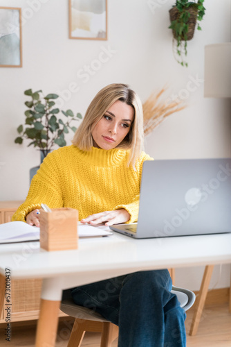 Focused woman working on laptop © The Attico Studio