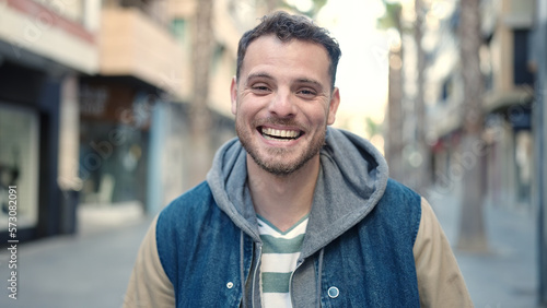 Young caucasian man smiling confident at street