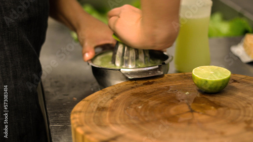 close up of a person cutting a lime