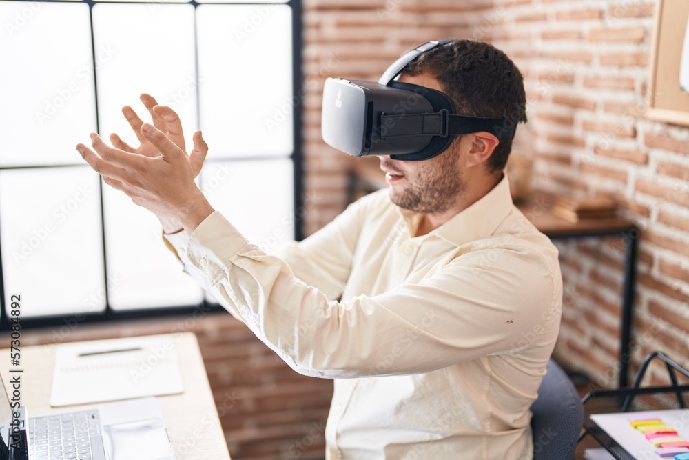 Young man business worker using virtual reality glasses at office