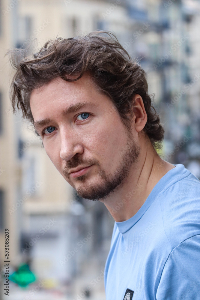 Handsome young man with blue eyes and curly wavy hair Handsome young man with blue eyes and curly wavy hair