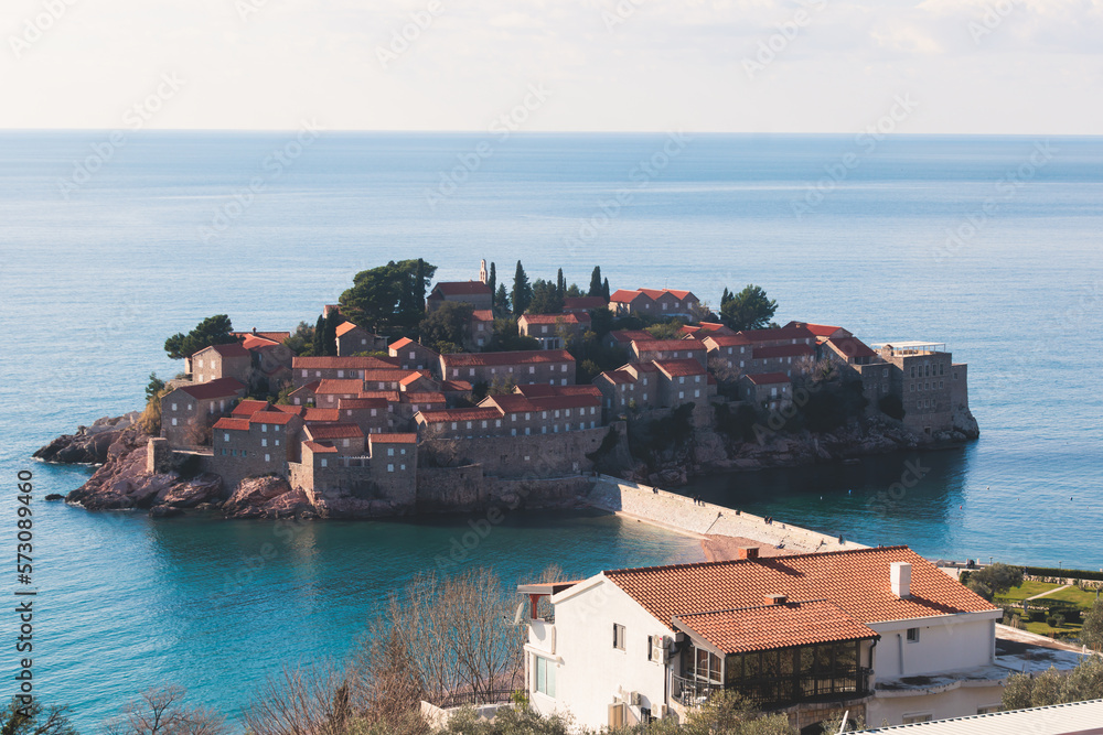 View of Sveti Stefan, a town in Budva Municipality, Budva Riviera, on the Adriatic sea coast, Saint Stephen island, Montenegro, sunny day with a blue sky, travel to Montenegro