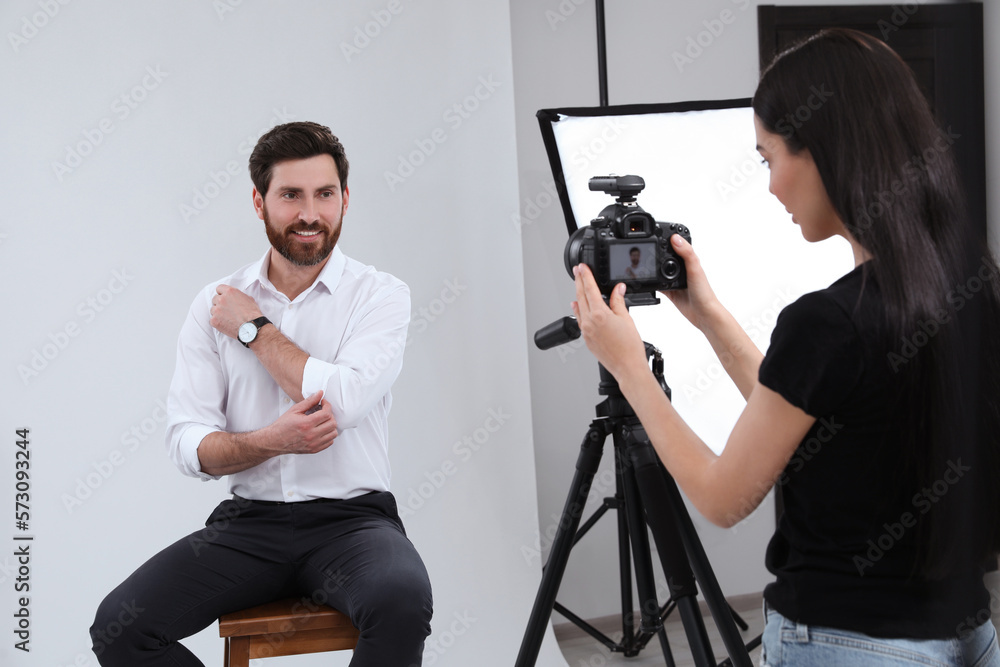 Obraz premium Professional photographer working with handsome model in modern photo studio