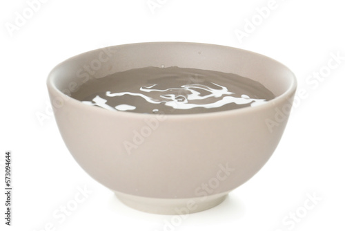 Ceramic bowl full of water isolated on white