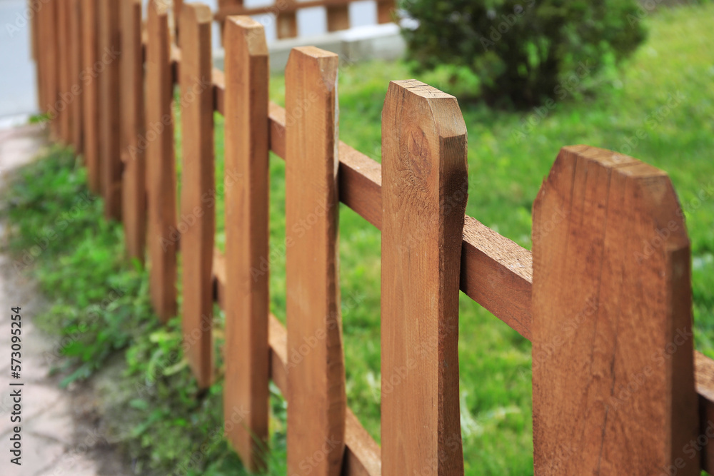 Small wooden fence on sunny day outdoors, closeup