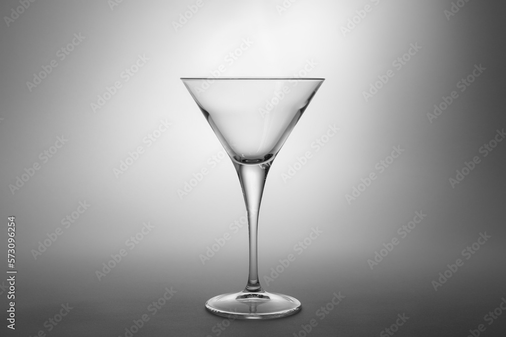 Elegant empty martini glass on grey background Elegant empty martini glass on grey background