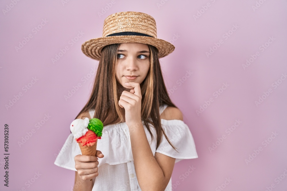 Teenager girl holding ice cream thinking worried about a question, concerned and nervous with hand on chin