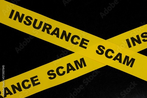 Obraz na płótnie Insurance scam and fraud alert, caution and warning concept. Yellow barricade tape with word in dark black background. w salonie
