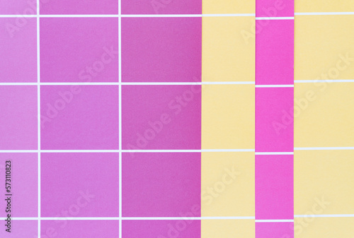 pink and yellow paper pad sheets with grid paint chip element - macro lens, particular focus
