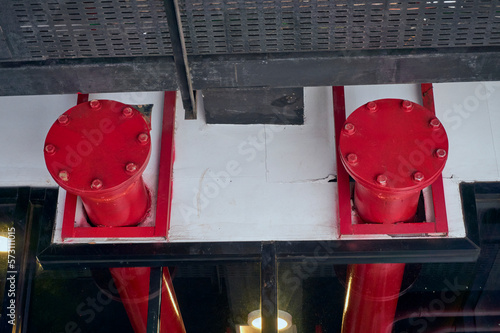 Red Firefighting Water Pipeline of Fire Protection Systems with bolted flange and blind or blank flange under roof with hanger for Security Fire Prevention. Emergency Fire Accident. Industry Equipment