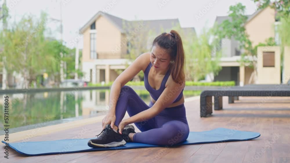 Woman athlete doing leg massage after workout. Knee pain. Painful sports injury. legs cramp muscle tension. Healthy flexible body. Female athlete hold the leg due to muscle injury after exercising. Woman athlete doing leg massage after workout. Knee pain. Painful sports injury. legs cramp muscle tension. Healthy flexible body. Female athlete hold the leg due to muscle injury after exercising.
