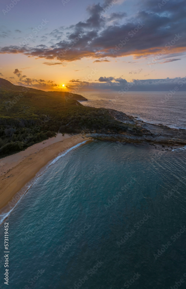 Fototapeta premium Rain cloud sunrise over the beach and mountain