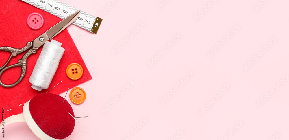 Set of sewing supplies with fabric on pink background with space for text Set of sewing supplies with fabric on pink background with space for text