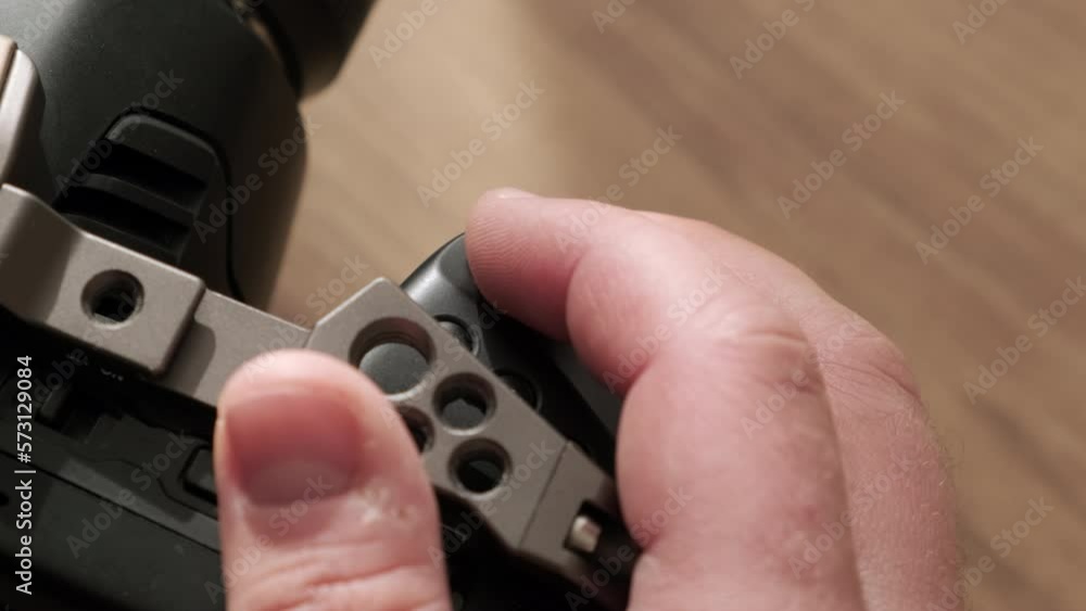 Top down view finger press record button on professional movie camera. Start recording podcast or interview in calm, sunny environment. Professional operator press button to start recording video. Top down view finger press record button on professional movie camera. Start recording podcast or interview in calm, sunny environment. Professional operator press button to start recording video.