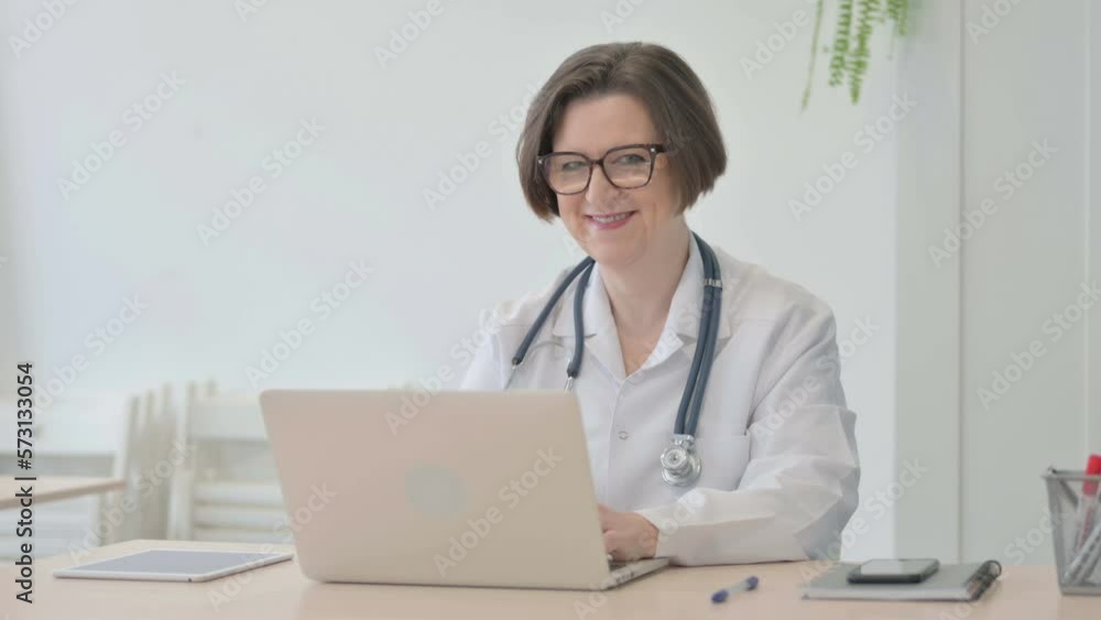 Thumbs Up by Senior Doctor Working on Laptop Thumbs Up by Senior Doctor Working on Laptop