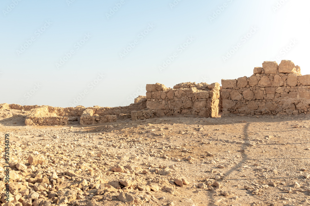 The remains  of internal buildings in the rays of the rising sun in the ruins of the fortress of Masada - is a fortress built by Herod the Great on a cliff-top off the coast of the Dead Sea, Israel