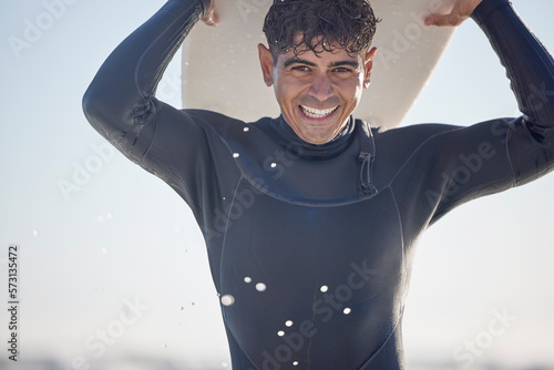 Sticker Portrait, vacation and man holding surfboard at the beach, sea or ocean with a smile and is happy on a summer day