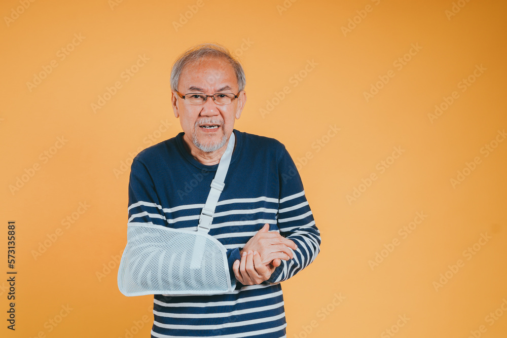Arm broken. Senior male sling support hand confident smile broken after accident wear arm splint for treatment show good sign. health insurance on mobile concept. Arm broken. Senior male sling support hand confident smile broken after accident wear arm splint for treatment show good sign. health insurance on mobile concept.