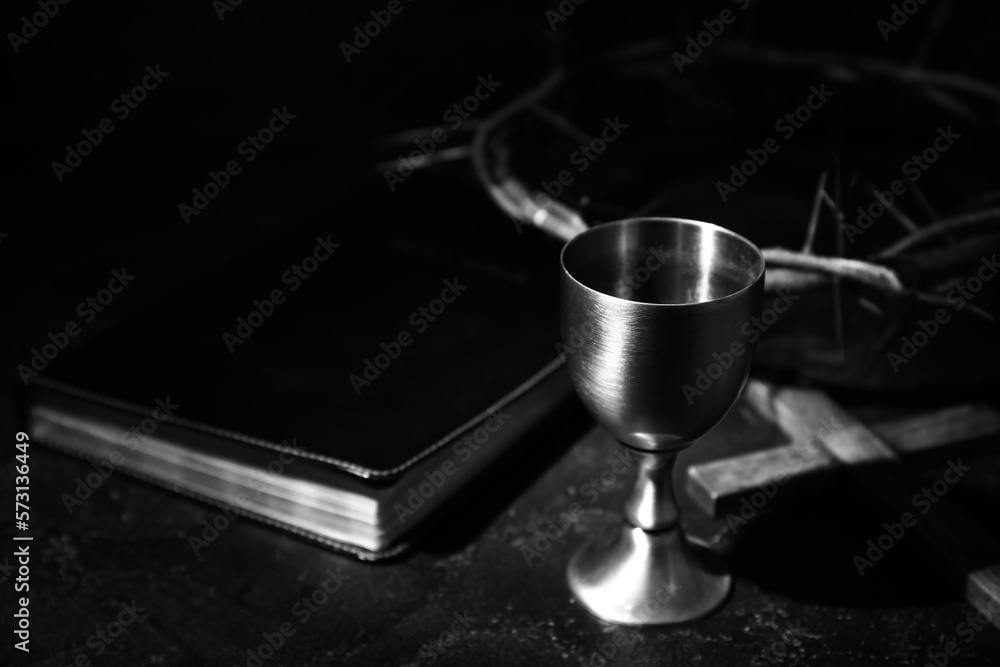 Wine cup, crown of thorns, cross and Holy Bible on dark background, closeup Wine cup, crown of thorns, cross and Holy Bible on dark background, closeup