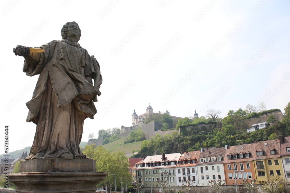 Marienberg Fortress viewed over a historic statue in Würzburg, Germany