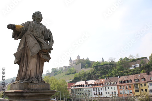 Marienberg Fortress viewed over a historic statue in Würzburg, Germany